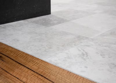 bathroom tiles meet Marri timber flooring in Master bedroom on Perth home