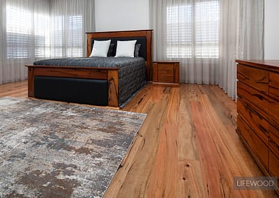 marri timber flooring in bedroom with grey rug